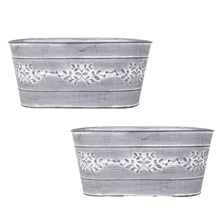 Pair of grey metal tin trough planters featuring decorative leaf vine patterns, with a rustic finish and curved edges, ideal for indoor or outdoor plants.