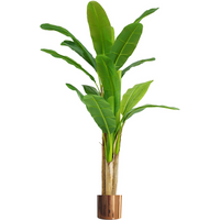 Artificial banana tree with large green leaves in a copper metal planter, 180cm tall.