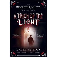 "Book 'A Trick of the Light' by David Ashton, dark cover with silhouette of man under streetlamp"