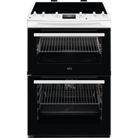 White AEG 60cm electric induction double cooker with black glass top, control knobs, and dual oven doors with glass panels.