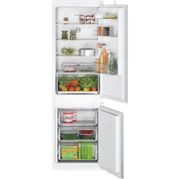 Bosch built-in fridge freezer with white interior, adjustable shelves, and clear drawers, stocked with food items.