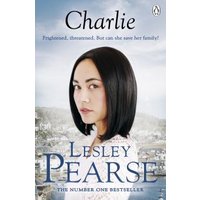 "Charlie book cover featuring a woman with dark hair against a cloudy sky and coastal town background"
