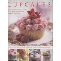 Cupcake topped with pink frosting and red berries on a decorative plate, surrounded by floral accents.
