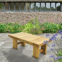 Wooden garden table, rectangular, natural finish, sturdy legs, 4'x2' size, set on a stone patio with greenery.