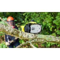 Yellow and black Garden Gear 20V telescopic chainsaw with battery, cutting a tree branch in a wooded area.
