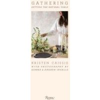 "Book titled 'Gathering' featuring a woman arranging flowers on a table with candles and a dark plate"