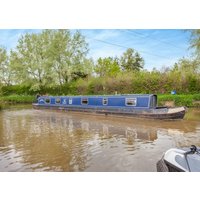 Blue narrowboat "Georgia" by Hoseasons on a calm river, surrounded by lush greenery and trees.