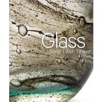 Textured glass surface with swirling brown and green patterns, featuring bubbles and the words "Glass Sand Ash Heat."
