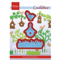 "Marianne Design Creatables die set featuring grass, birdhouse, and bird shapes in blue and red outlines."