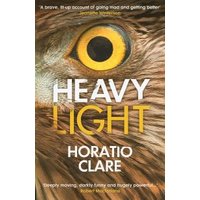 "Heavy Light book by Horatio Clare, cover featuring a close-up of an owl's eye and brown feathers."