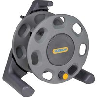 Gray Hozelock floor-standing hose reel with circular frame, side handle, and yellow center logo.