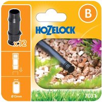 Black Hozelock MICRO End Plug, cylindrical with ridged grip, shown in packaging with garden hose setup.