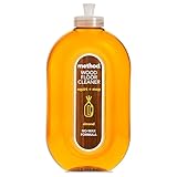 Clear oval bottle of Method Wood Floor Cleaner with orange liquid and almond scent label, 739 ml capacity.