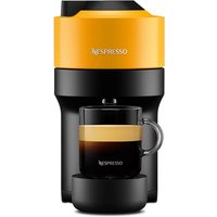 Mango yellow Nespresso Vertuo Pop coffee machine with black base, brewing espresso into a clear glass cup.
