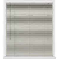 White Nomad window blinds with horizontal slats and pull cords, framed by a white window casing.