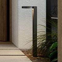 Round black Nordlux Rica LED solar path light with sleek design and downward-facing illumination.