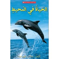 Book titled "OCEAN LIFE" featuring two dolphins jumping out of the ocean against a blue sky background.