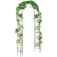 Metal garden arch with intricate scrollwork, 226H cm, adorned with green leaves and pink flowers.