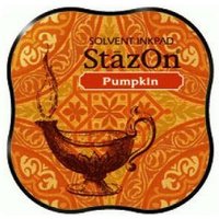 Orange Tsukineko StazOn ink pad with ornate floral pattern and vintage lamp illustration.