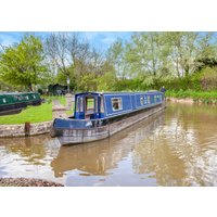 Blue and white narrowboat "Rachel" by Hoseasons on a calm river, surrounded by lush greenery and moored boats.