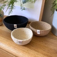 Set of three Respiin jute mini bowls in pebble colors: black, beige, and cream, displayed on a wooden surface.