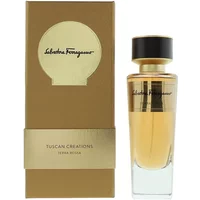 Gold-capped perfume bottle with brown label, beside matching gold and brown box, Salvatore Ferragamo branding.