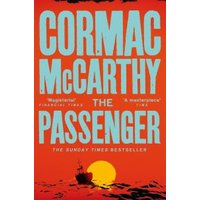 Red cover of "The Passenger" by Cormac McCarthy with bold yellow text and a sunset silhouette of a boat.