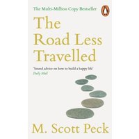 Paperback book "The Road Less Travelled" by M. Scott Peck, white cover with stone path graphic and orange text.
