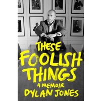 Black and white memoir cover with yellow text, featuring a man in a suit seated at a table.
