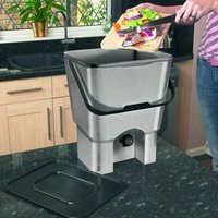 Gray Twin Pack Bokashi Compost Bin with black lid and handle, shown on a kitchen counter with food scraps being added.