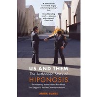 "Book 'Us and Them' by Mark Blake, cover shows two men shaking hands, one on fire, in an industrial setting"