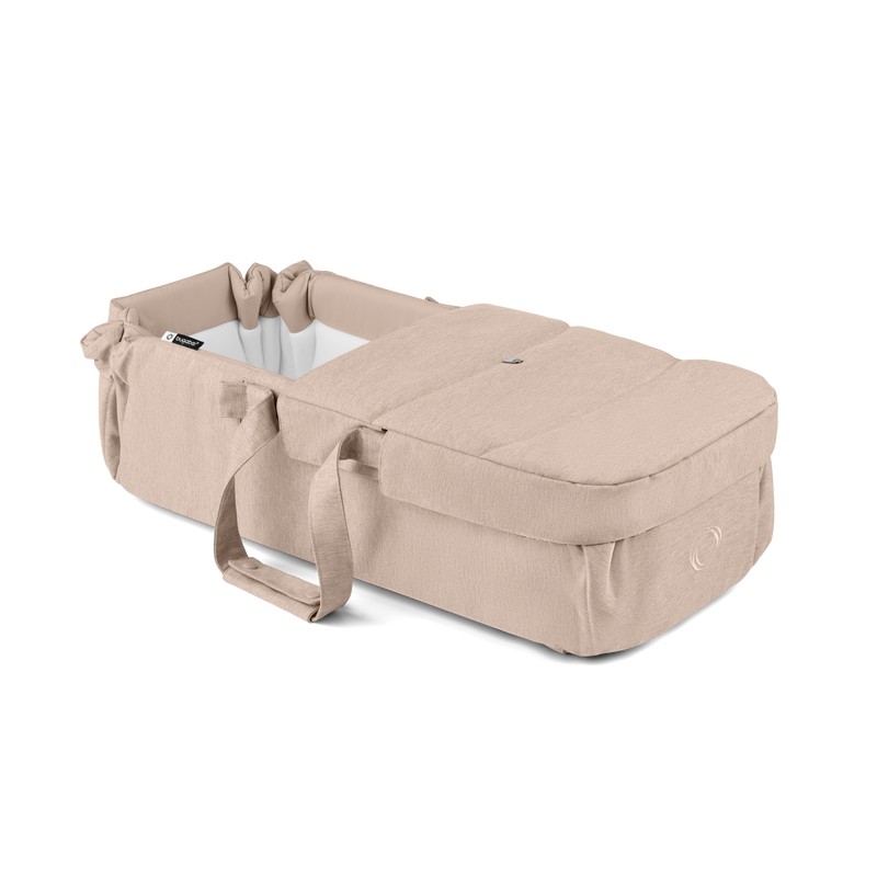 Light beige Bugaboo Baby Nest featuring a soft, padded exterior, a cozy interior, and adjustable straps for secure attachment to strollers.