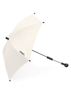 Light beige Bugaboo Parasol+ with a flexible arm, featuring a circular logo and a sturdy silver pole, designed to provide shade for strollers.