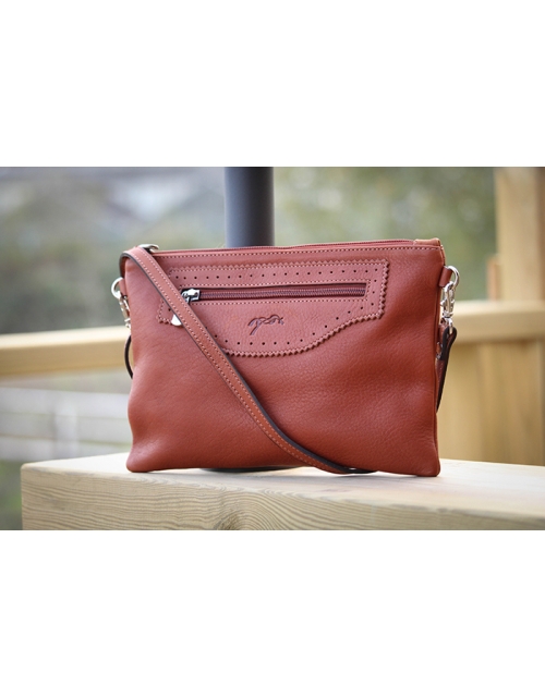 Brown leather women's clutch with a textured finish, featuring a front zip pocket and an adjustable strap for versatility.