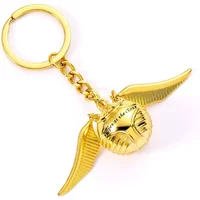 Golden Snitch keychain with detailed wings and chain, inspired by Harry Potter, by The Carat Shop.
