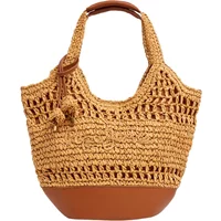 Beige woven tote handbag with brown leather handles and base, featuring intricate crochet patterns.