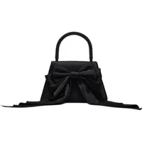 Black Steve Madden Cosette handbag with large front bow, structured top handle, and sleek, elegant design.