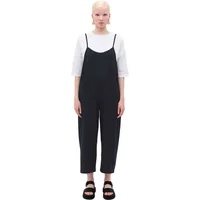 Black women's overalls by Rita Row, featuring thin straps and wide legs, worn over a white top.