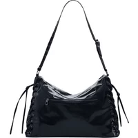 Black patent leather shoulder bag with lace-up sides, adjustable strap, and front zip pocket.