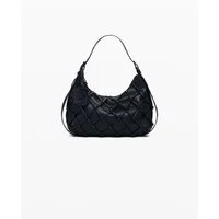 Black quilted Desigual Iridio Margot shoulder bag with curved shape and single strap.