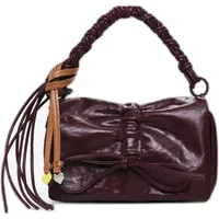 Maroon Desigual Rodio Naron Mini Flap shoulder bag with braided handle, bow detail, and tassel accents.