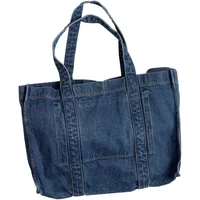 Blue denim Women's tote bag with double handles and front pocket detailing.