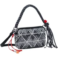 Zigzag Denim Shoulder Bag by Desigual with braided handle, tassel detail, and geometric patterns.