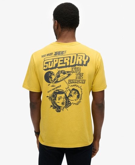 Yellow loose-fitting patterned T-shirt featuring a retro comic-style graphic on the back with the text "SUPERDRY" and illustrations of a planet and characters.