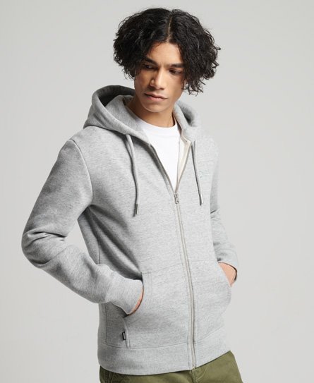 Light grey organic cotton hooded sweatshirt by Superdry, featuring a zip front, drawstring hood, and side pockets, styled with a white t-shirt underneath.