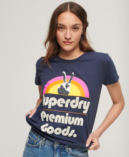 Navy blue women's T-shirt featuring a retro Superdry logo in cream and pink with a peace sign graphic, made from soft cotton for a casual, comfortable fit.