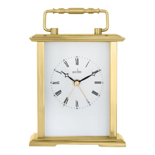 Polished gold metal carriage clock with a white face, black Roman numerals, and a gold hour and minute hand, featuring a decorative handle on top.