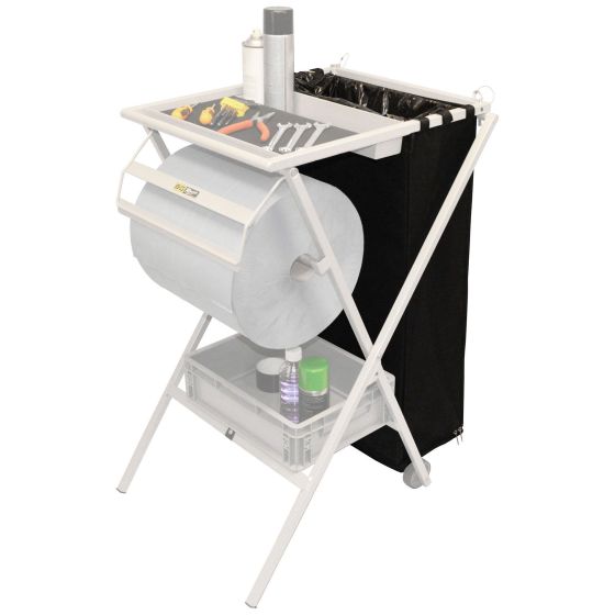 B-G Racing Bin Facade features a white metal frame with a folding design, a roll of paper, a black fabric bin, and a top shelf holding tools and spray cans.