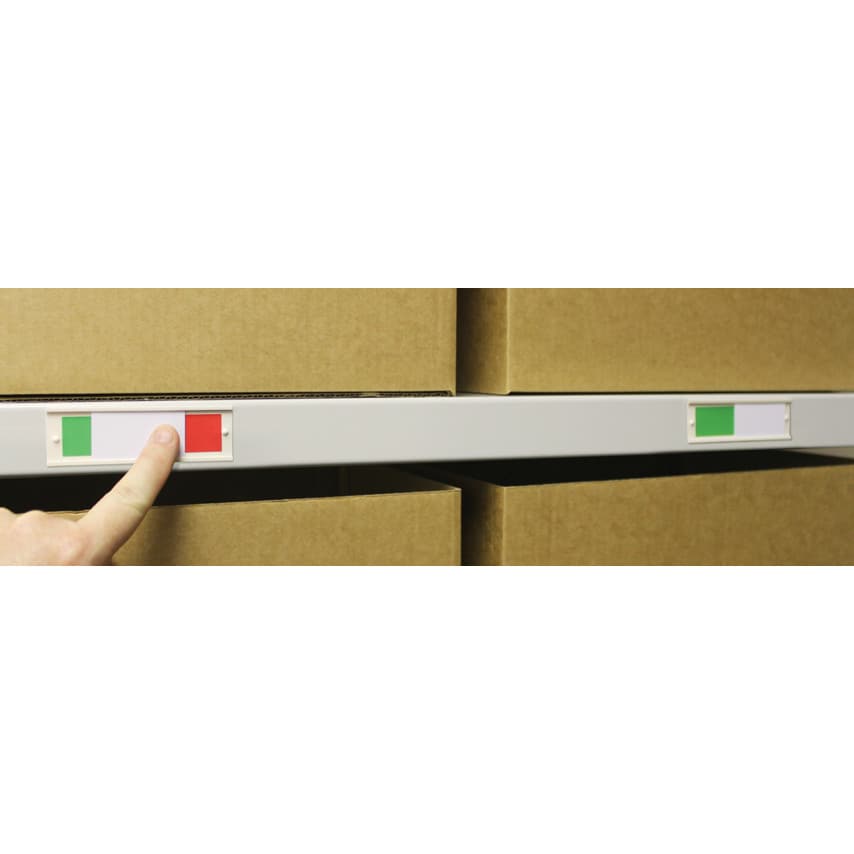 Self-adhesive two-colour stock identity sliders in red and green, designed for easy labeling, shown applied to a storage shelf with cardboard boxes.