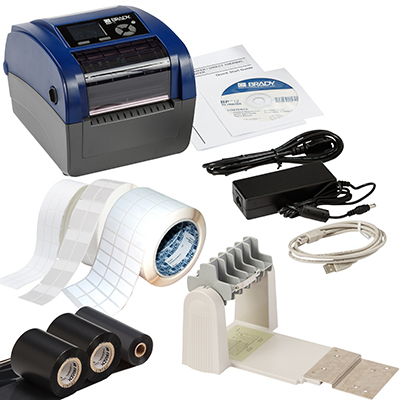 Brady BBP12 label printer in blue and gray, with power supply, USB cable, labels, and a roll holder, showcasing direct thermal and thermal transfer capabilities.
